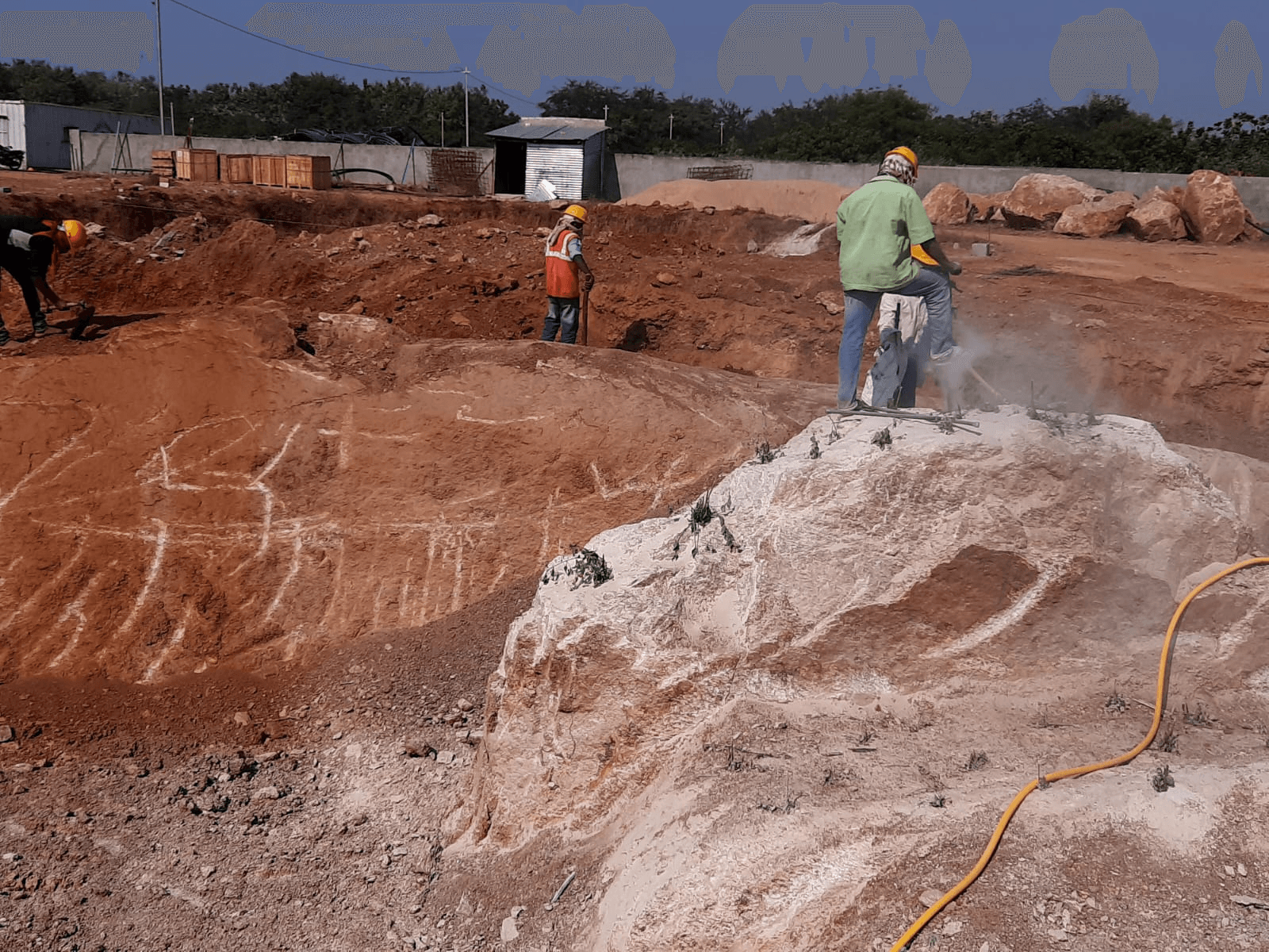 Workers wearing helmets during supervised site operations